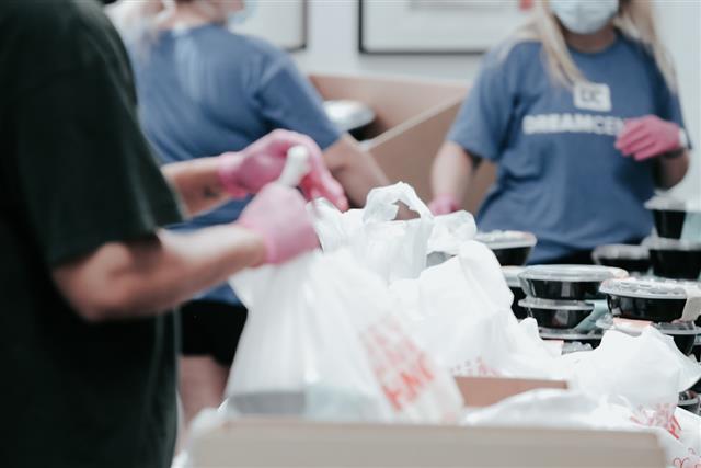 Volunteer holds a bag of donated groceries at a food bank